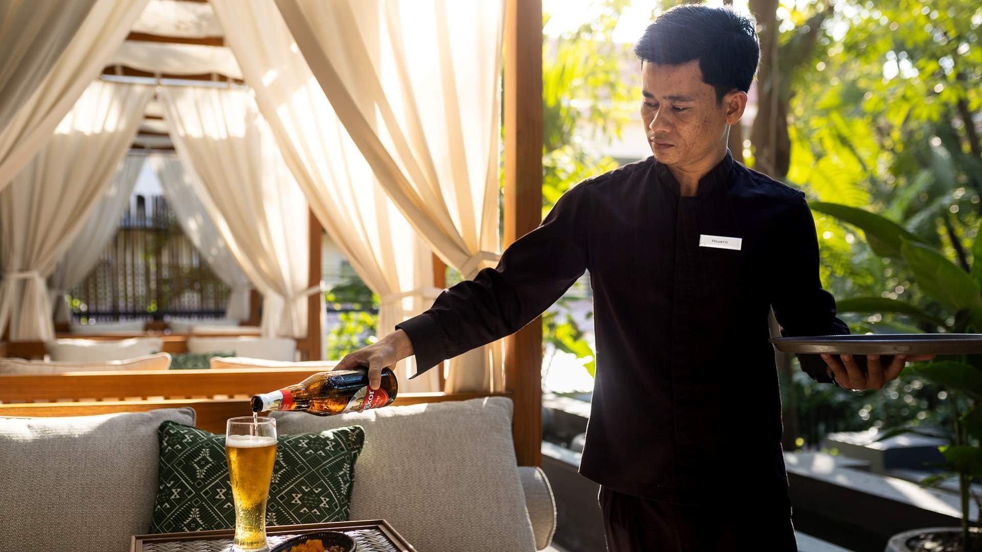 Mekhala Bar and Restaurant waiter pouring drinks
